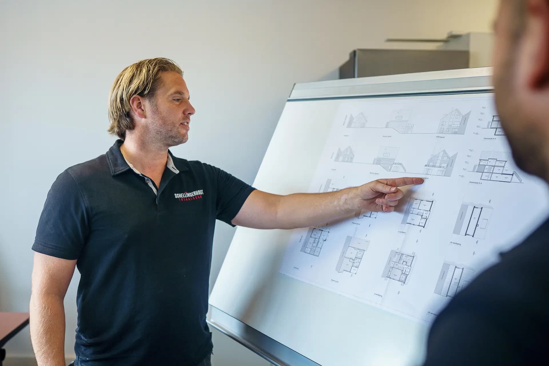 A Schellingerhout site planner walking a colleague through construction drawings.